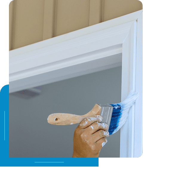 Hand painting door frame with blue brush.