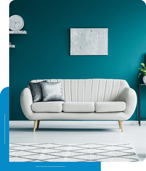 Modern minimalist living room with grey sofa and blue wall.